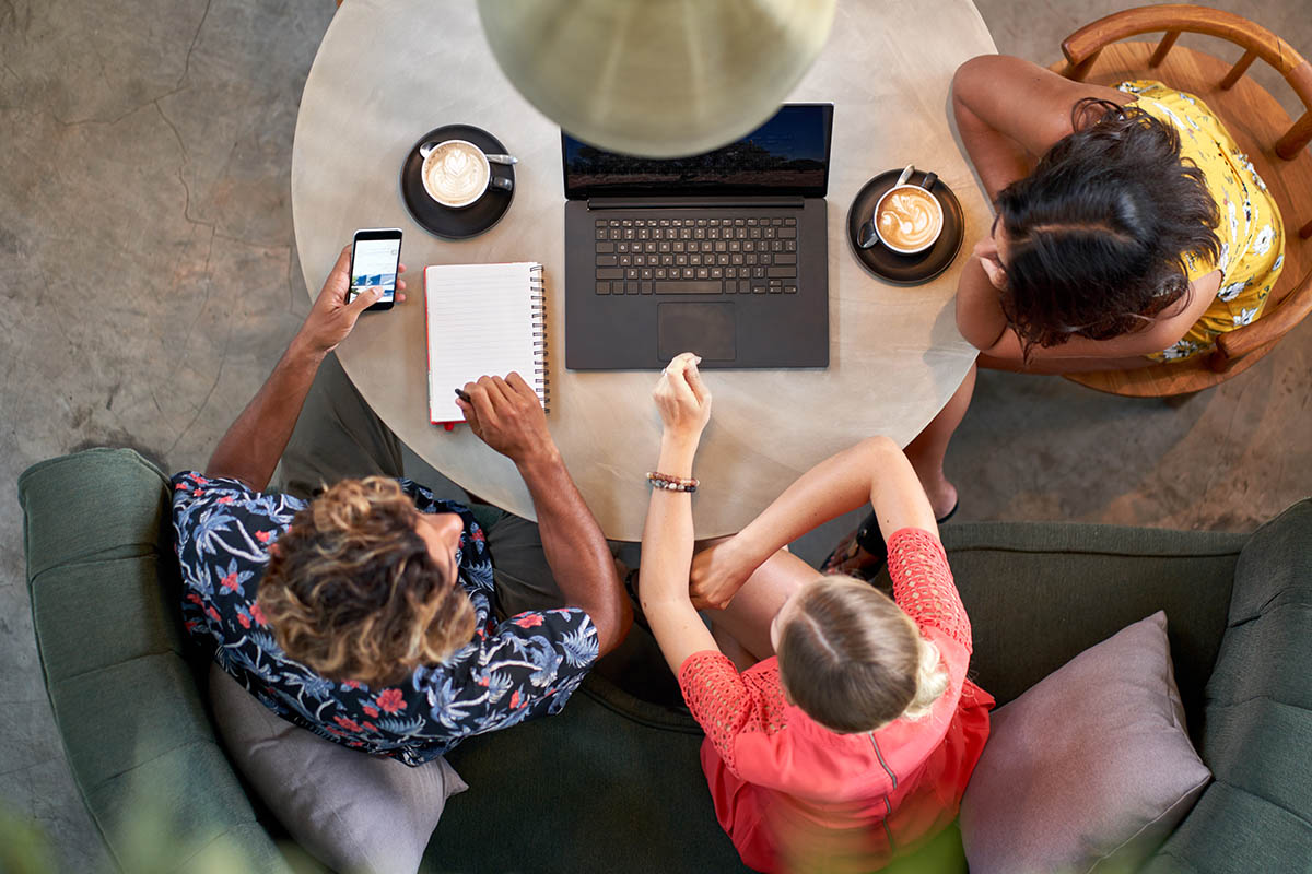 Common Work Area with Three Business People Collaborating